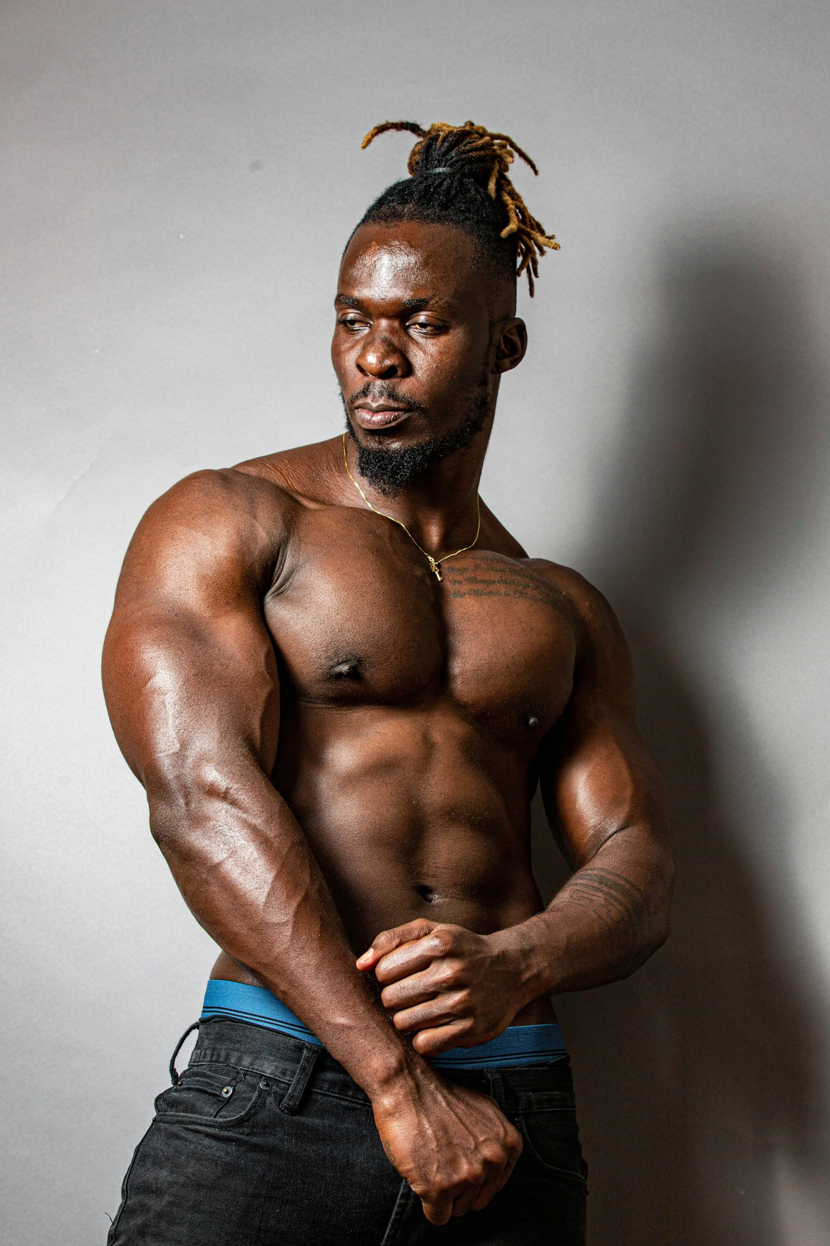 Muscular African American man showcasing strength in a striking pose.
